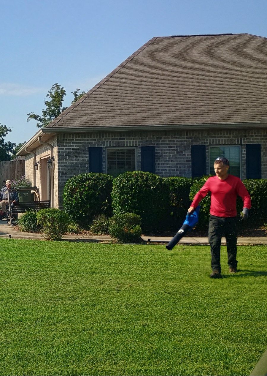 Another finished yard off the route — clean edges and healthy green turf up to the brick home