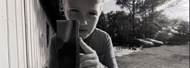 Holding a freshly sharpened mower blade up to the camera