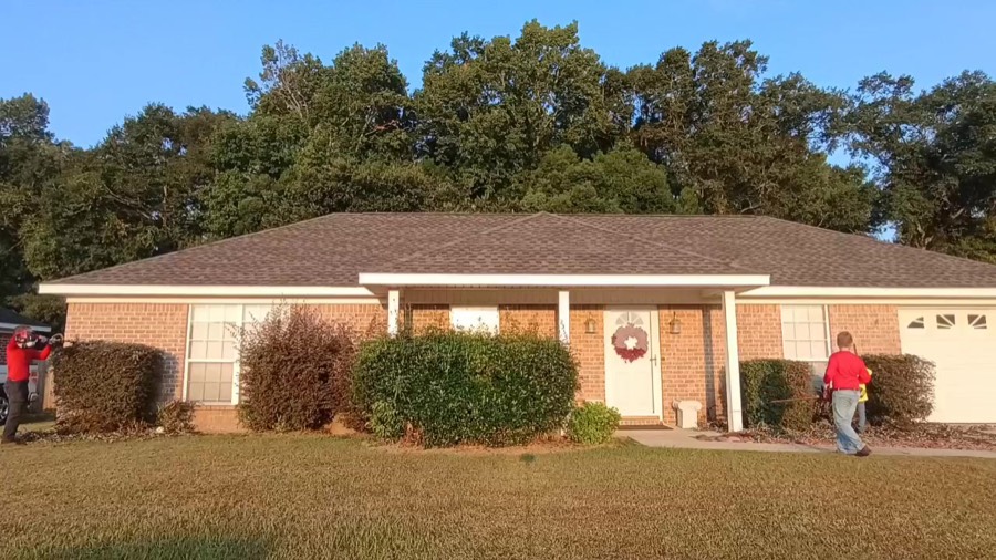 Our crew trimming the front hedges at a brick home
